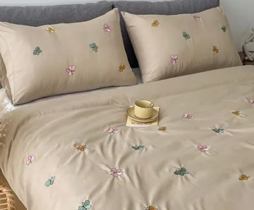 Full view of beige butterfly and floral bedsheet